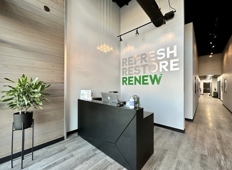 A reception area with a sign that says nutritional iv therapy, vitamin injection refresh restore renew.